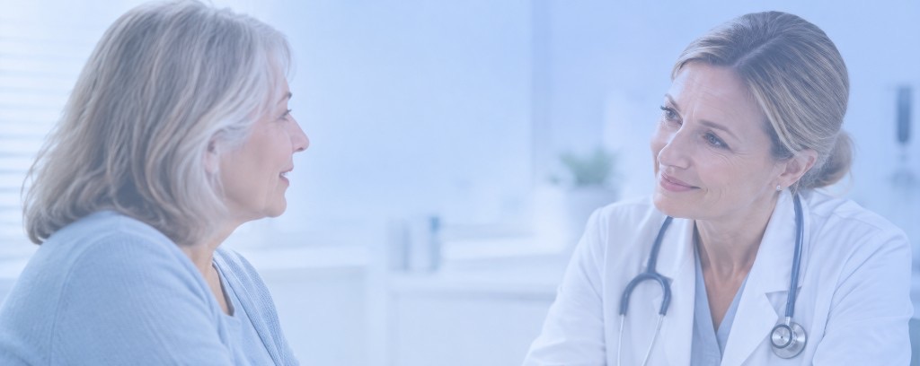Clinician speaking with an older patient during a visit