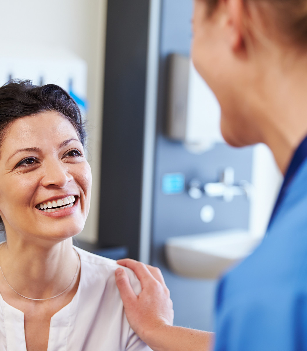 Patient smiling during a visit with a clinician